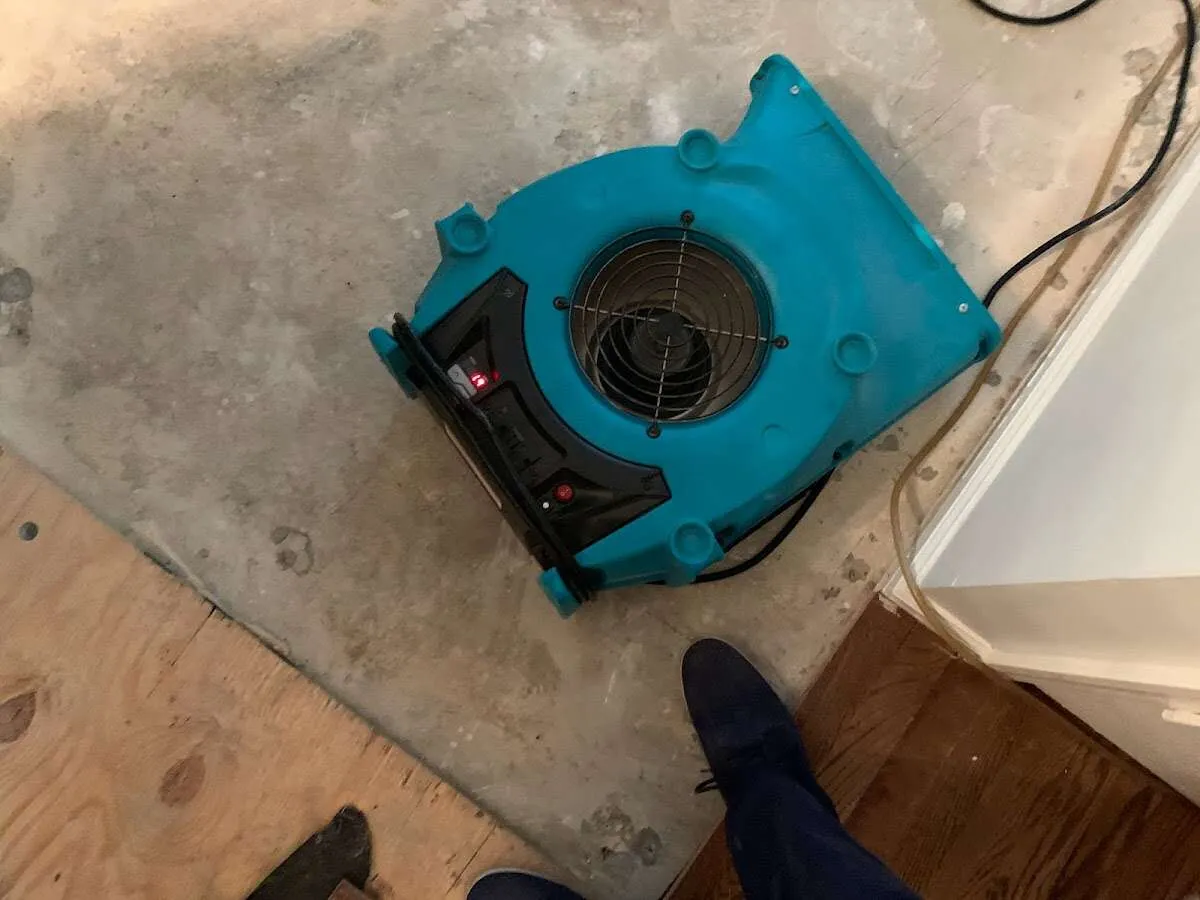 Air mover drying subfloor during Commercial Water Damage Restoration in Joshua Tree